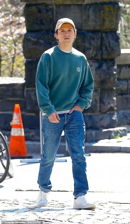 Tom Holland keeps it laid-back in a crew neck and denim as he reunites with longtime acting coach Ben Perkins in Central Park, NYC