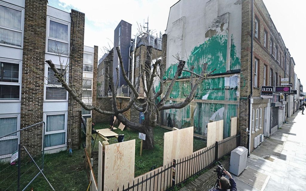 Plastic-covered mural of a tree in London by Banksy fenced off following suspected vandalism