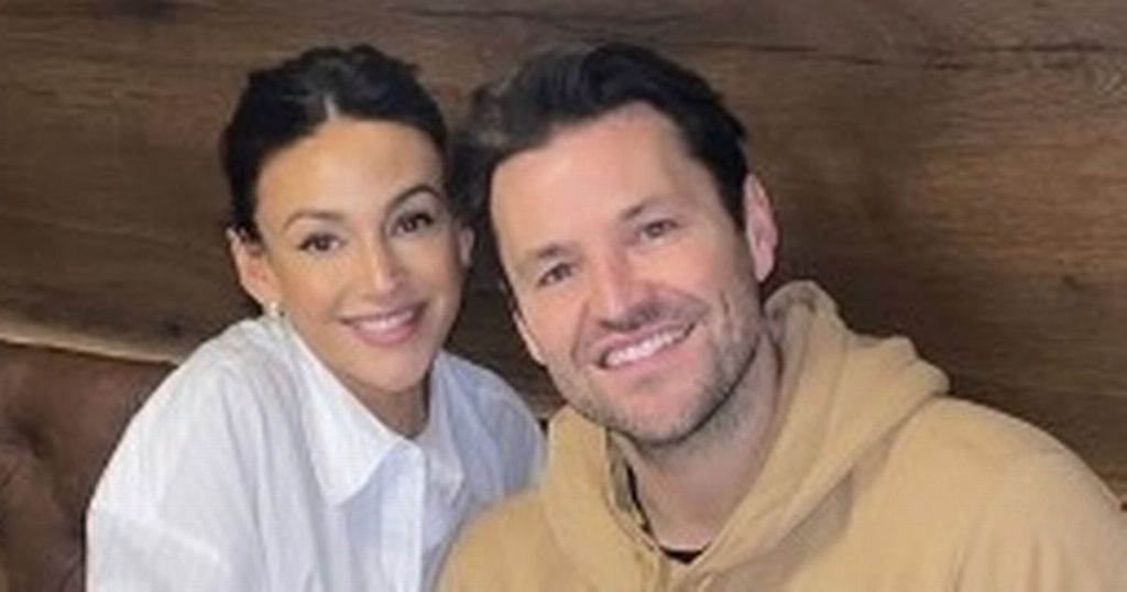 rewrite this title Mark Wright and Michelle Keegan smile in defiant appearance after burglary horror