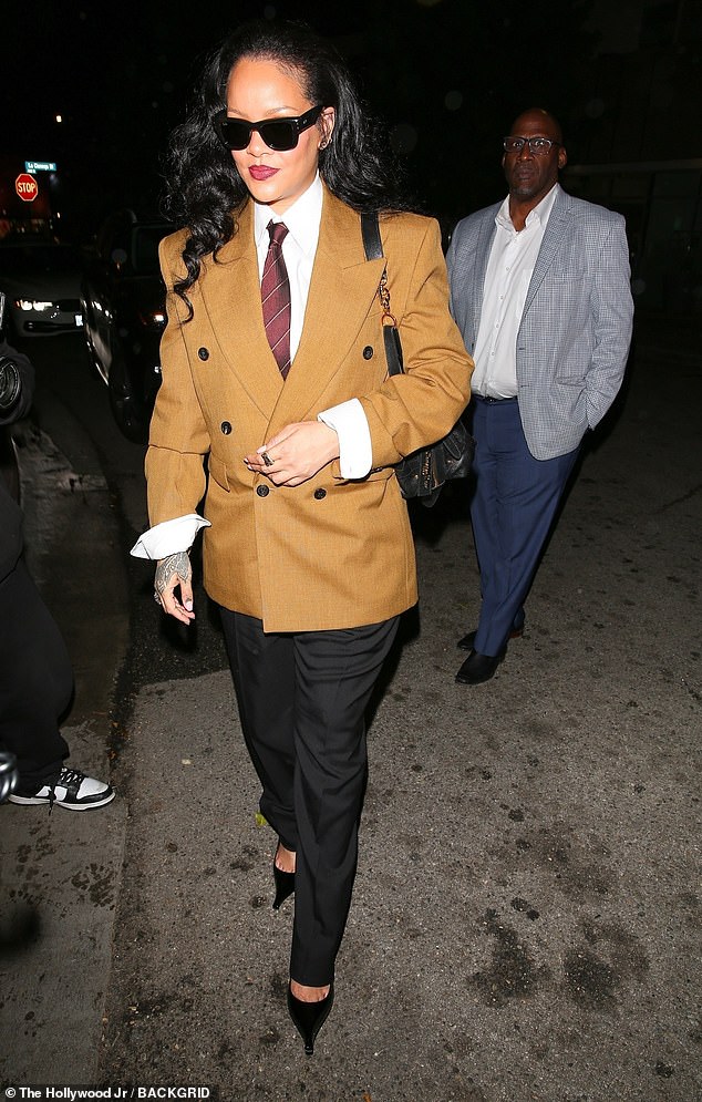 rewrite this title Rihanna wears a stylish androgynous suit as she rings in her 37th birthday with A$AP Rocky and celebrates his not guilty verdict