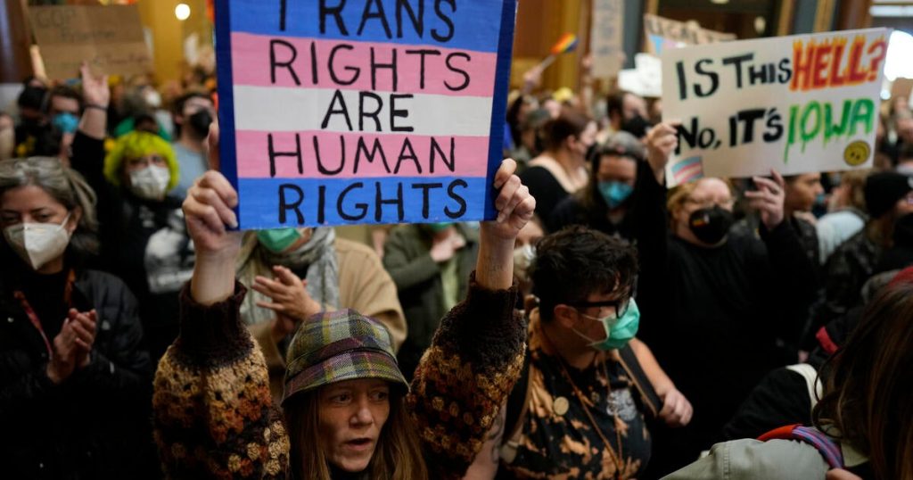 rewrite this title Transgender rights protections ended under bill hastily OK’d by Iowa lawmakers despite large, intense protests
