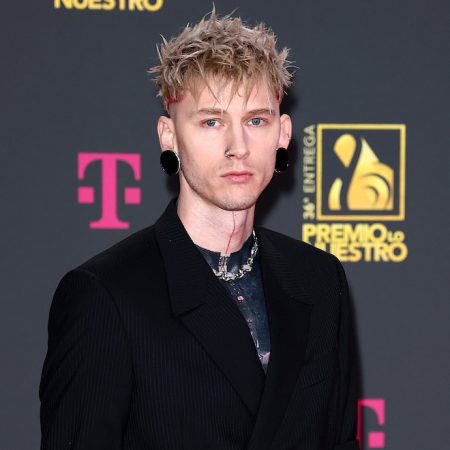 rewrite this title Machine Gun Kelly Puts His Black Ink Tattoos, Man Bun On Full Display