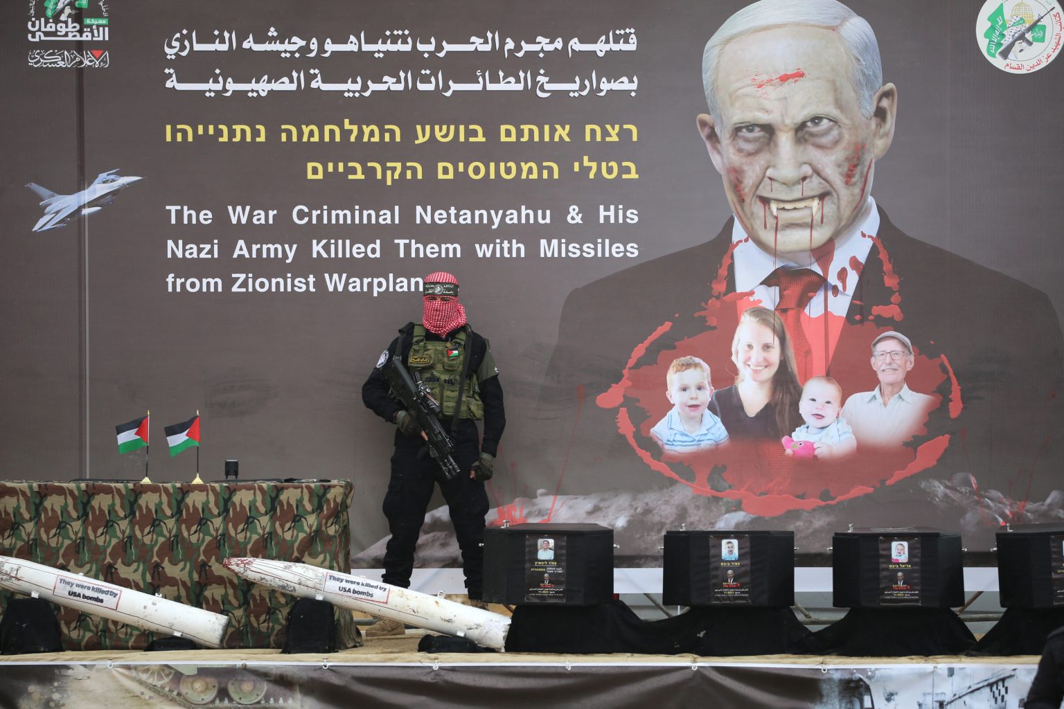 rewrite this title Hamas Displays 4 Black Coffins Ahead of Hostage Remains Handover