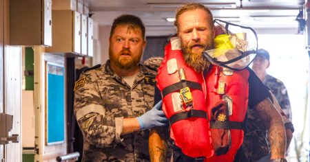 rewrite this title Australian navy rescues adventurer who hit a cyclone while rowing across the Pacific Ocean