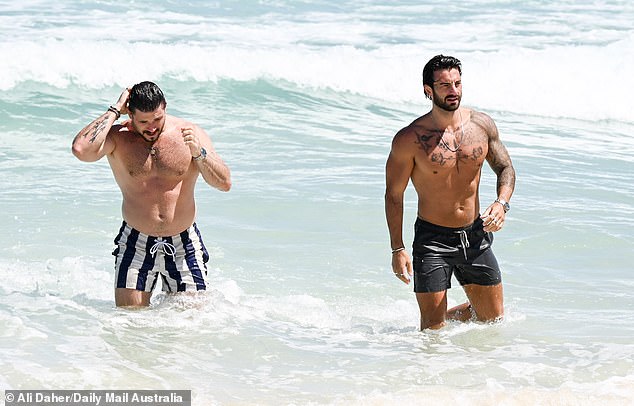rewrite this title Married At First Sight grooms Eliot Donovan and Paul Antoine show off their chiseled physiques as they take a dip in the ocean