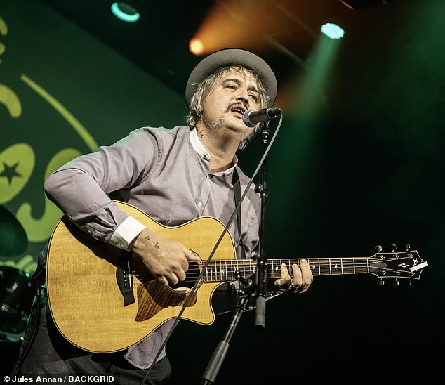 rewrite this title Pete Doherty performs on stage with his beloved pet dog – after revealing he’s at risk of having his toes amputated amid diabetes diagnosis