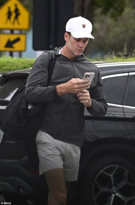 rewrite this title Glum Tom Brady checks his phone after red hot pictures emerge of Gisele Bundchen in clinch with new baby daddy