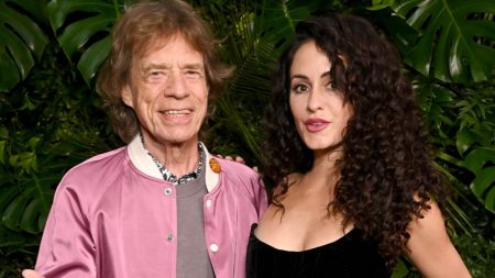 rewrite this title Mick Jagger Makes Rare Appearance With Girlfriend